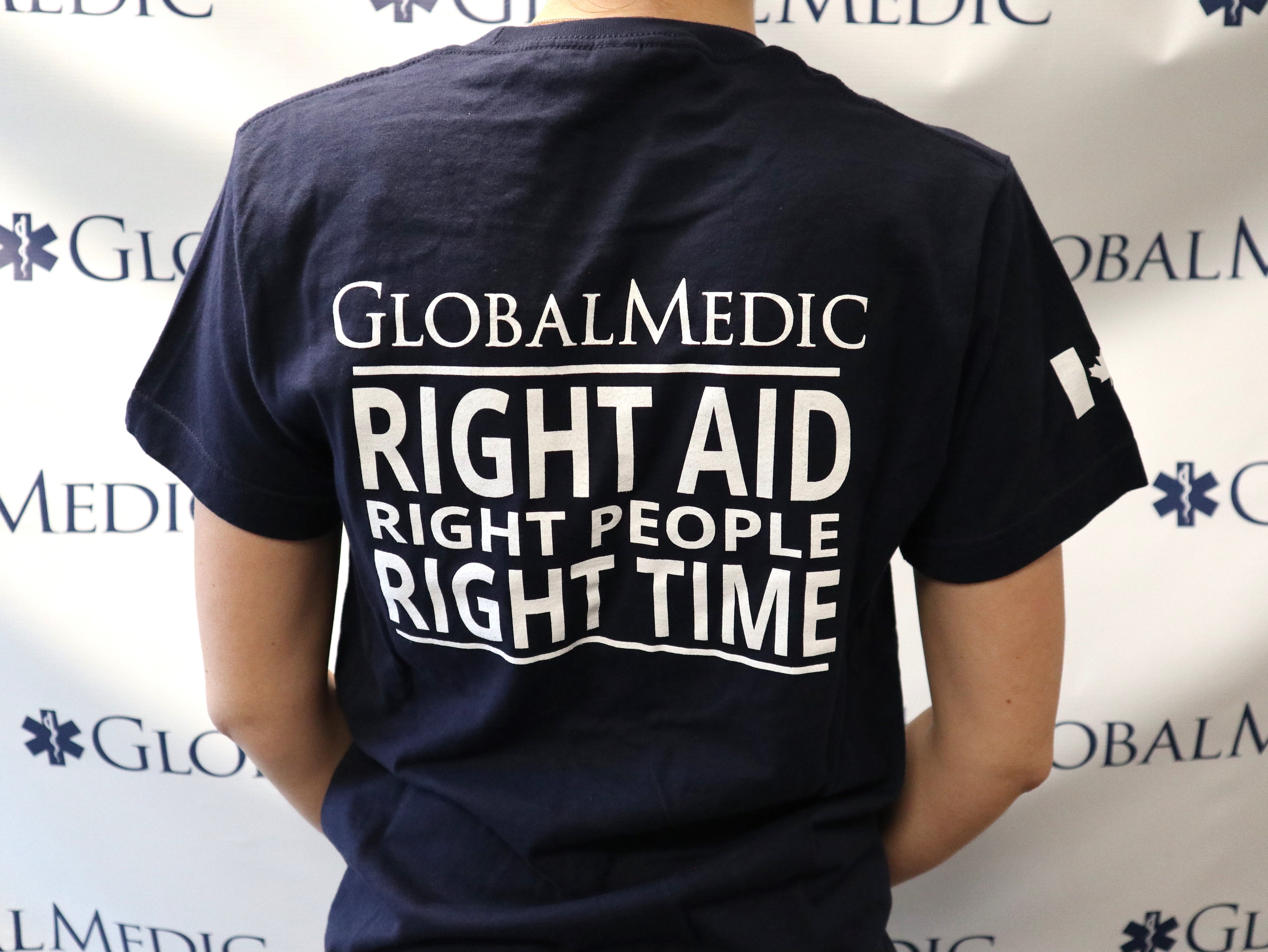 back of a woman wearing a blue GlobalMedic t-shirt
