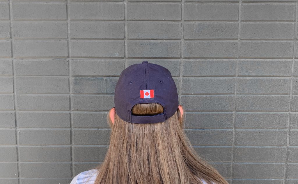 back of a women wearing a blue GlobalMedic hat