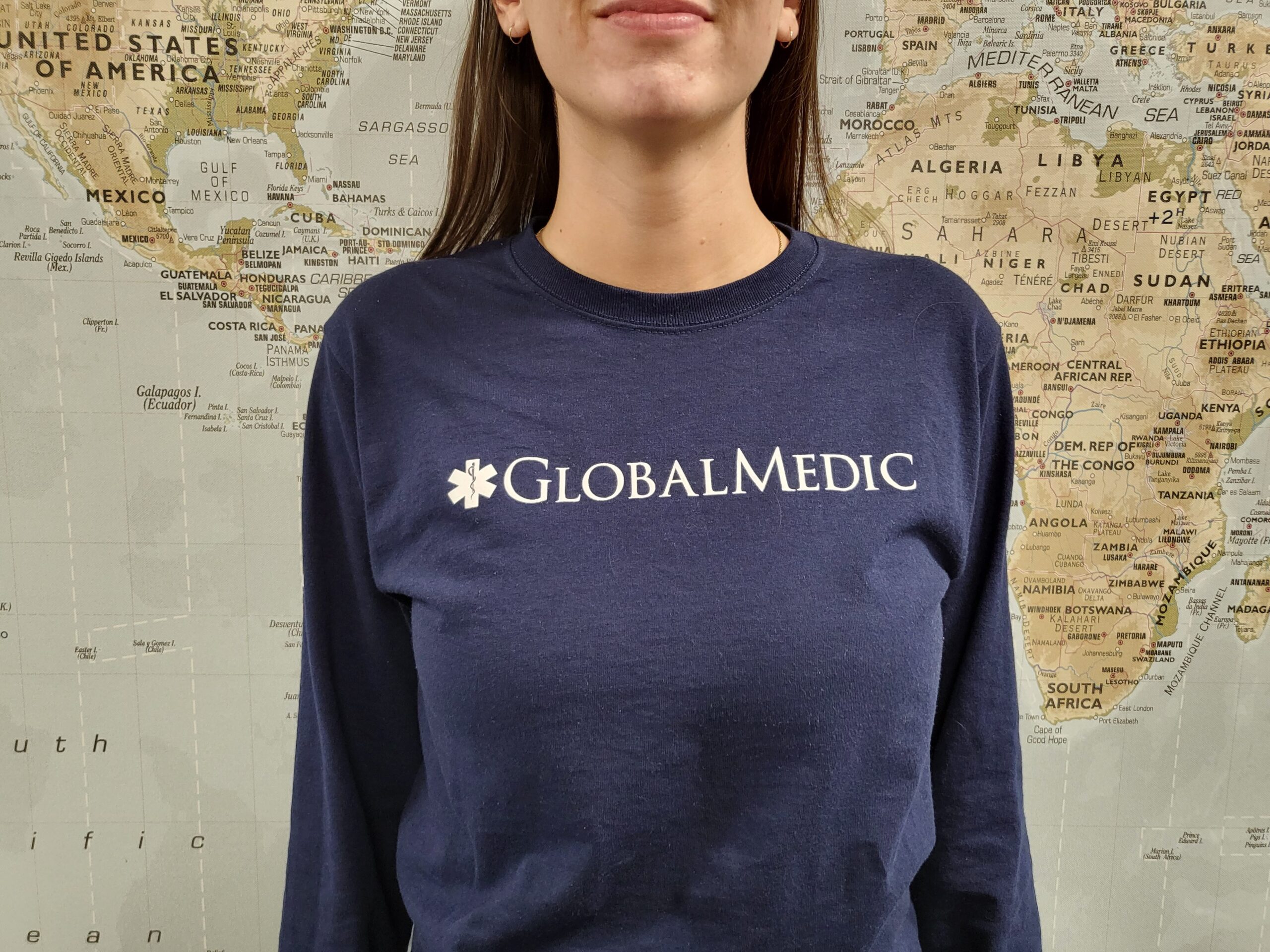 Front of a man wearing a blue GlobalMedic long sleeved shirt