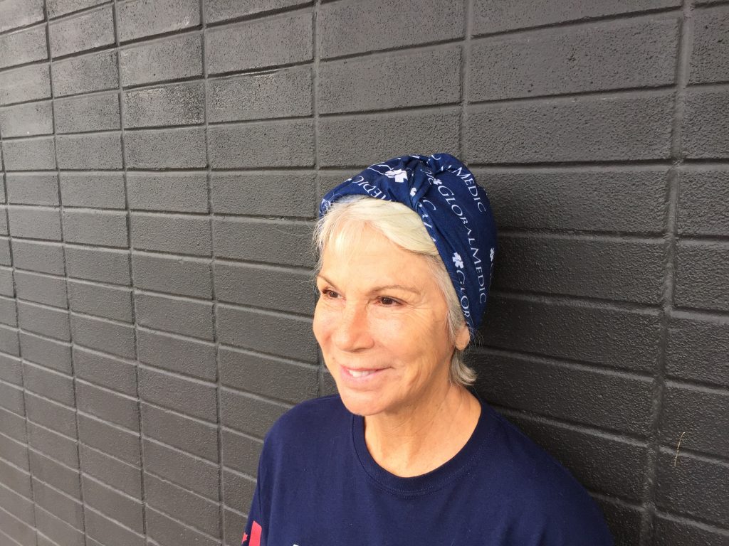 Women wearing a GlobalMedic Fandana on her head