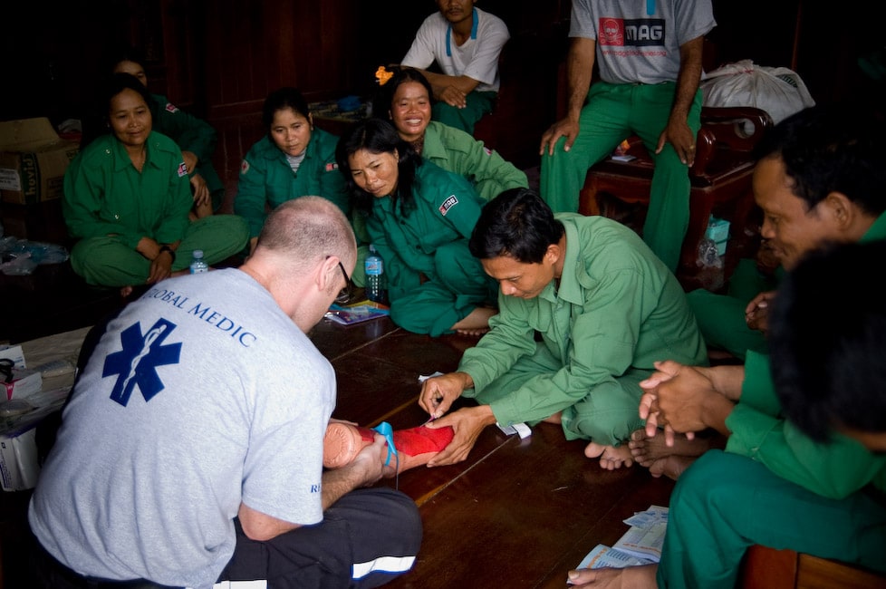 Rapid Response Team member leading first aid training for a group of Mines Advisory Group staff