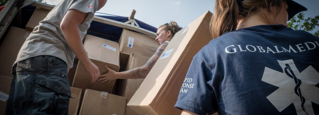 GlobalMedic Rapid Response Team members unloading boxes from a truck
