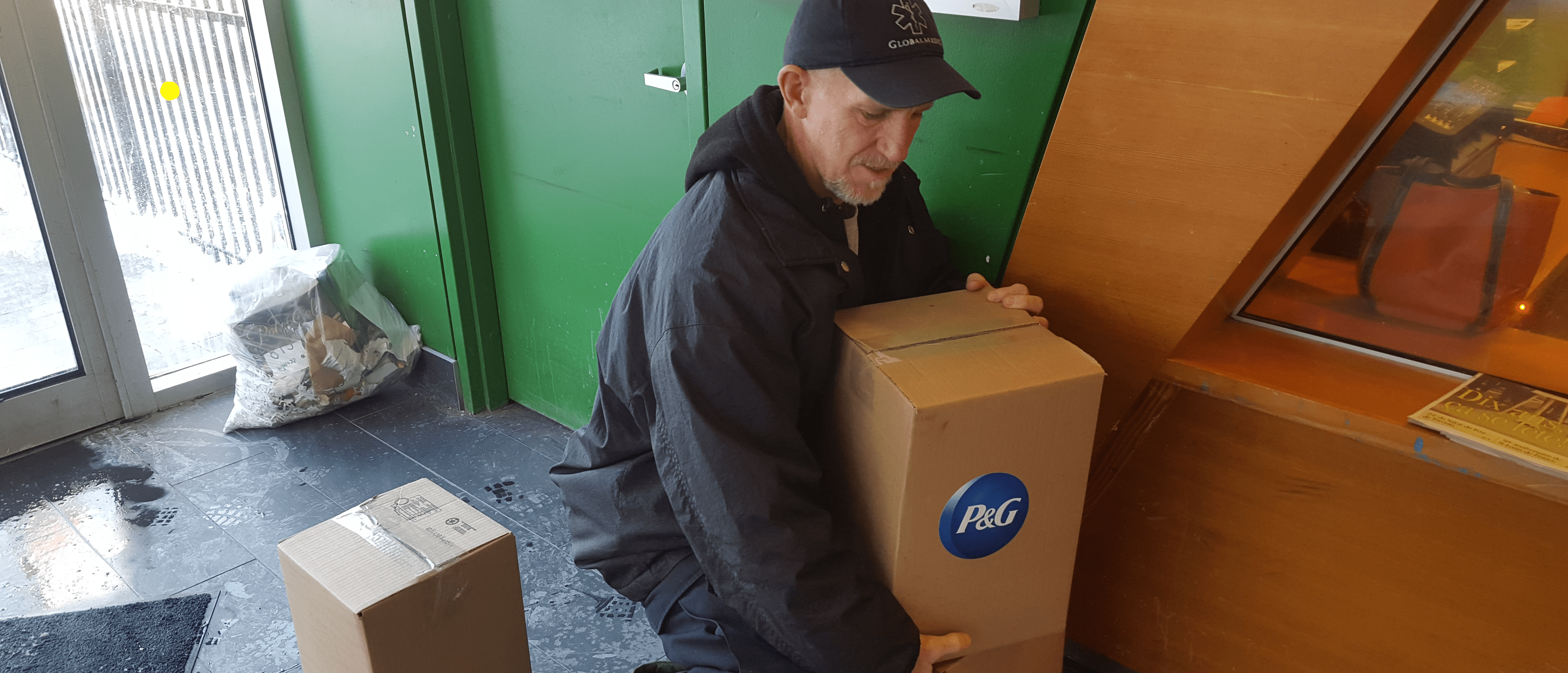 GlobalMedic volunteer delivering a box of hygiene kits
