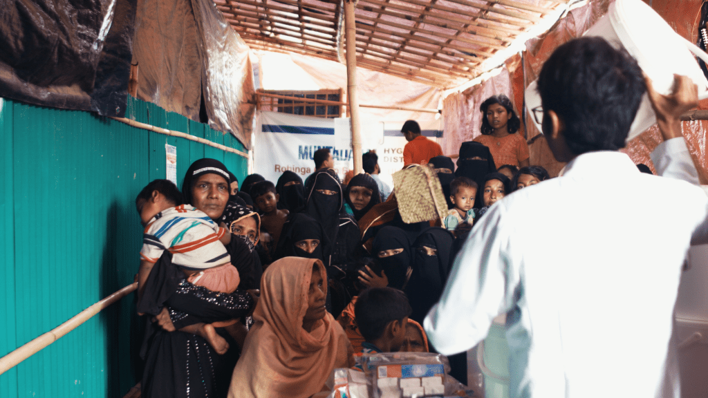 A line of Rohingya refugees waiting to receive Family Emergency Kits