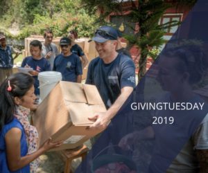 GlobalMedic team member handing out a Family Emergency Kit with the text "GivingTuesday 2019" overplayed across the image