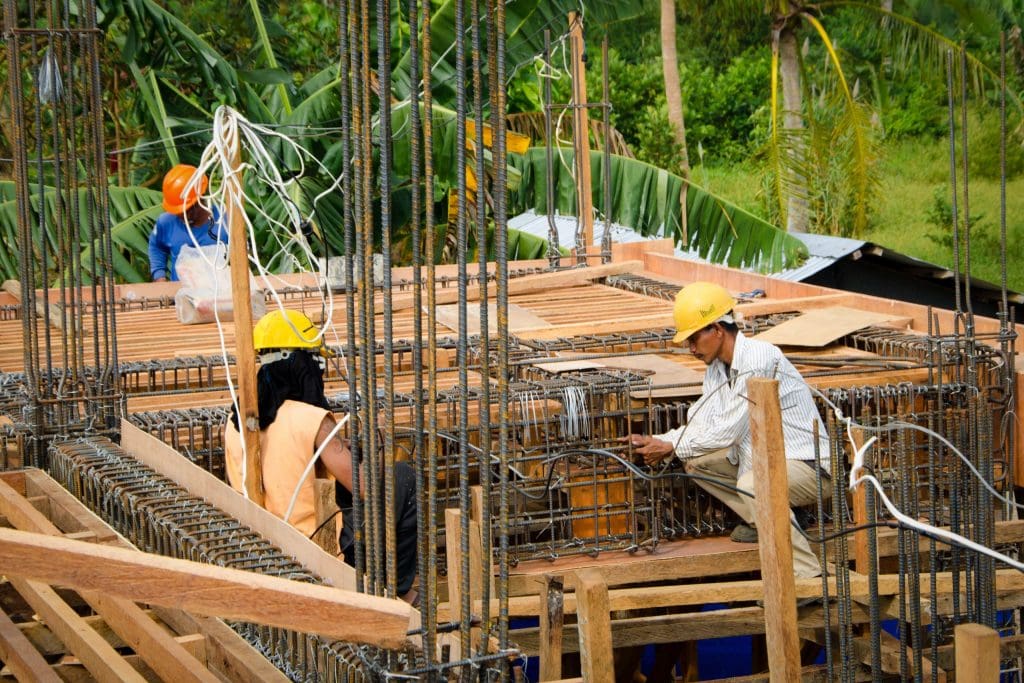 Local labourers constructing the second floor of the storm shelter