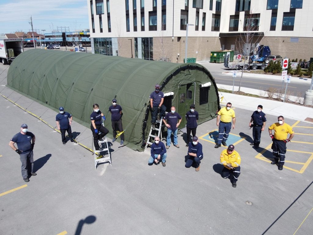 Aerial view of a crowd standing in front of critical infrastructure tenting at Etobicoke General Hospital