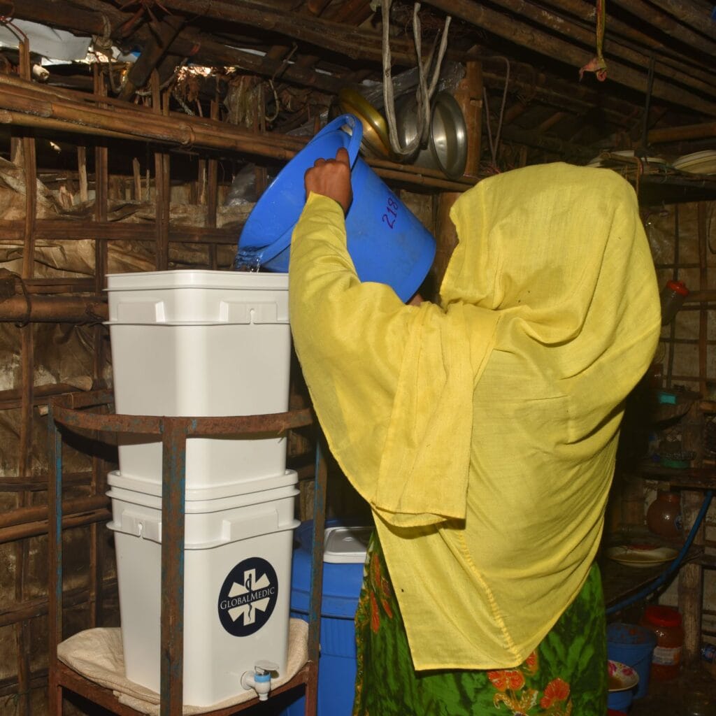 A woman pouring water into water purification unit