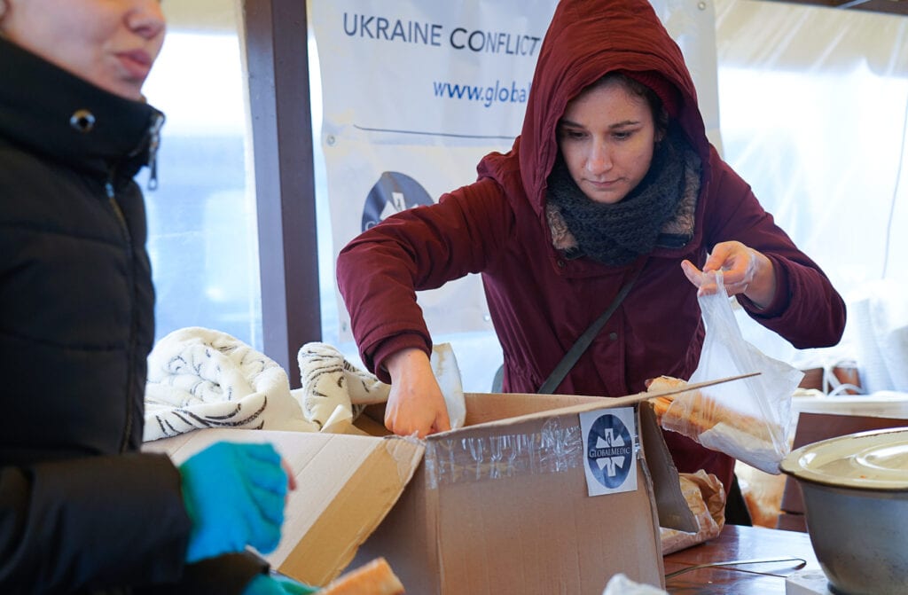 A woman getting supplies at soup kitchen in Moldova