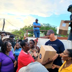 volunteer handing out aid in Jamaica